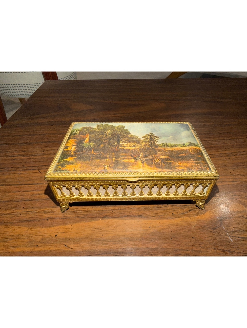 Vintage ornate gold tone jewelry box with scenic lid